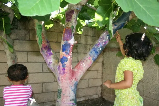 Sisters painting a tree