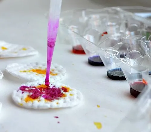 dropping watercolors on cotton rounds