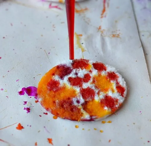 dropping liquid watercolors on cotton rounds spring art project for kids