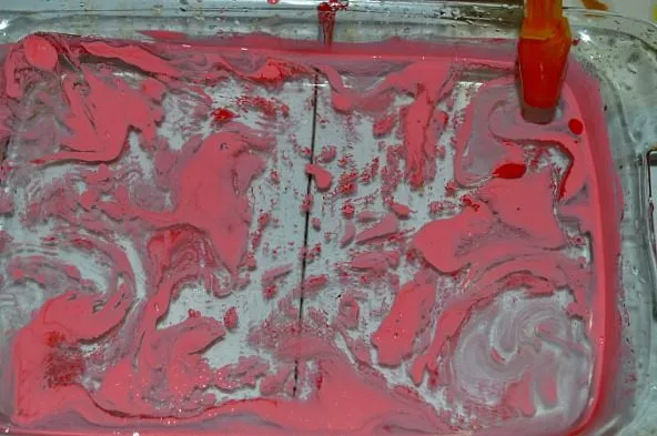 dropping pink oil paint for easy art projects for kids