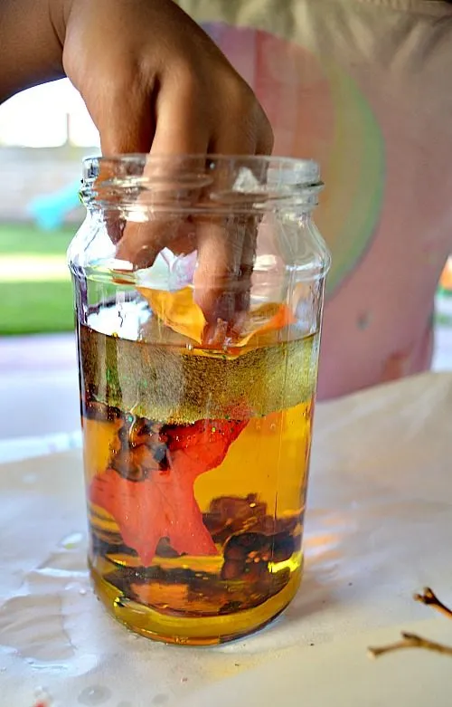 adding fake leaves to fall discovery bottles