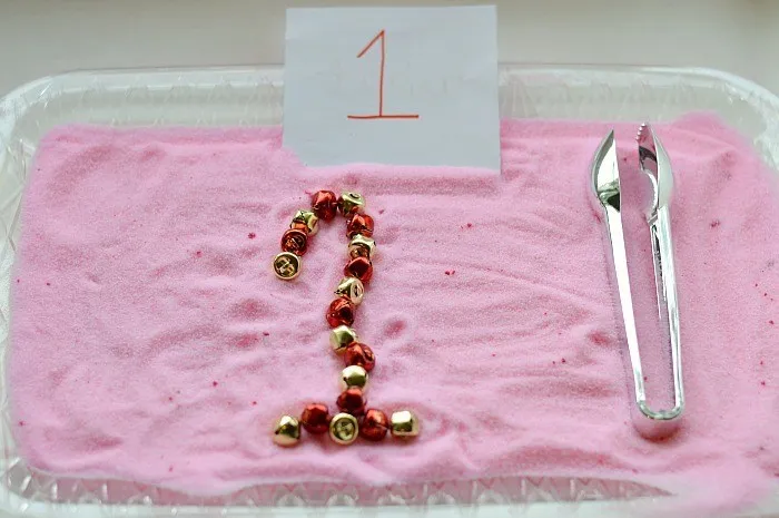 writing with jingle bells on peppermint tray