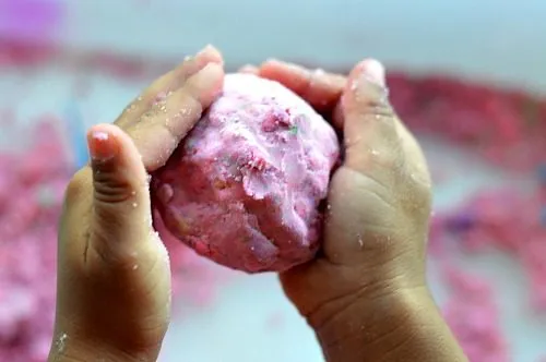 child making a cloud dough ball