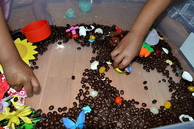 playing in sensory bin as sensory activities