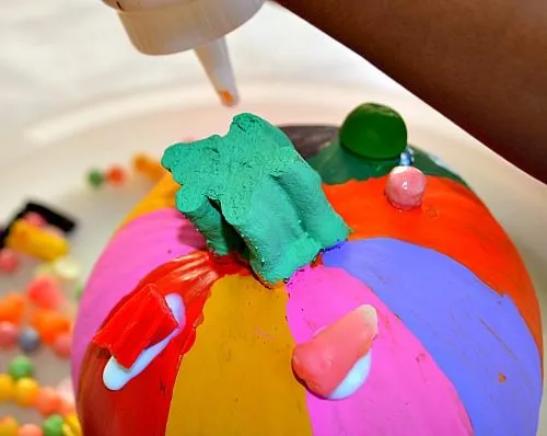 glue with candy on pumpkins