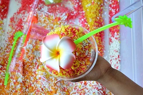 making pretend shakes with sensory rice