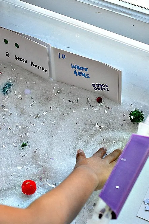 looking for items in the snow sensory bin